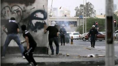 Anti-government protesters clash with riot police during protests Thursday outside Manama in Bahrain.