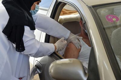 A man in Saudi Arabia receives a dose of a vaccine against Covid-19 at a drive through centre in the kingdom. The drive-through centres are open centres in Riyadh, Makkah, Madinah and Abha. AGP