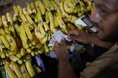 A salesman counts rial banknotes at a market in Bandar Abbas, Iran. Wana / Reuters