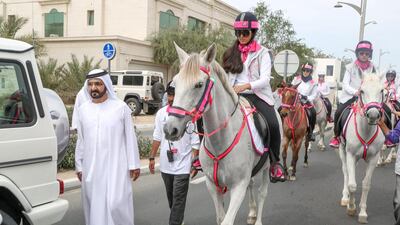 Sheikh Mohammed bin Rashid, Vice President and Ruler of Dubai, joins the Pink Caravan Ride, walking alongside his daughters, Sheikha Salama and Sheikha Shamma. Courtesy Dubai Government Media Office