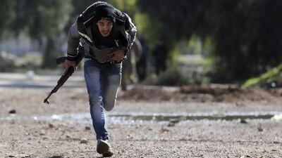 A Free Syrian Army fighter runs for cover in a suburb of Damascus. The rebels may be facing an even greater threat than traditional weapons.