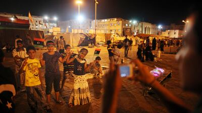 People take pictures as they celebrate what they believe is the nearly end of the military conflict against Gadhafi's regime at the rebel-held town of Benghazi, Libya, early Tuesday, Aug. 23, 2011. World leaders said Monday the end is near for Moammar Gadhafi's regime and began looking at Libya's future without the man who has held power there for 42 years. (AP Photo/Alexandre Meneghini)