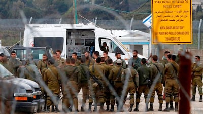 Israeli soldiers prepare at the Quneitra border crossing of the Israeli annexed-Golan Heights. March 23, 2019. AFP
