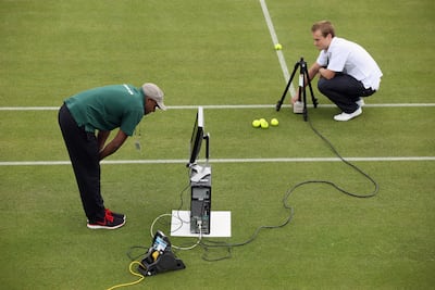 Hawk-Eye technicians check their ball-detection systems at the All England Lawn Tennis and Croquet Club before the Wimbledon Lawn Tennis Championships in 2011. Getty Images