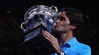 Federer of Switzerland kisses the Norman Brookes Challenge Cup beating Andy Murray in 2010. Getty