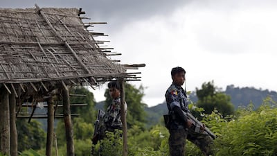 Myanmar police officers stand guard at Yebawkya village of Maungdaw township in Rakhine State, western Myanmar, in September 2017. EPA