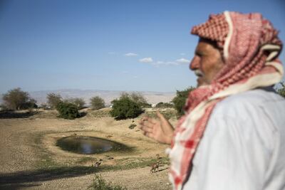 Palestinian shepherd Abu Ibrahim gestures towards a nearly dry reservoir in the West Bank village of Auja in the Jordan Valley. Heidi Levine for The National