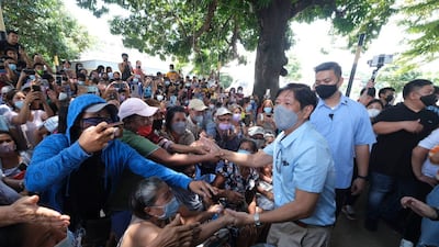 Philippine President Ferdinand Marcos Jr greets residents during his visit a day after a strong quake struck Bangued, Abra province, on July 28. AP Photo