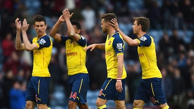 Aaron Ramsey, second right, and Arsenal teammates Laurent Koscielny, left, Francis Coquelin, second left, and Nacho Monreal, far right, celebrate after a win in the Premier League last month. Laurence Griffiths / Getty Images / April 11, 2015