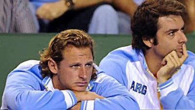 David Nalbandian, left, looks on with fellow Argentina teammate Agustin Calleri as Fernando Verdasco of Spain defeats Jose Acasuso to seal the Davis Cup for the Spaniards.