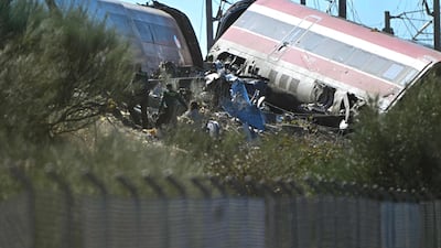 A derailed carriage and twisted metal on the embankment following the crash. AFP