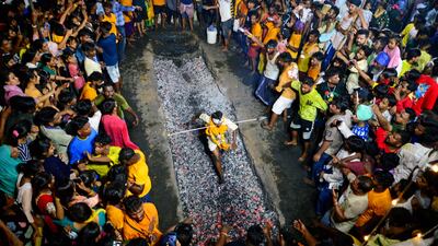 A Hindu devotee runs on burning coal during the Maa Maariamma Mela festival in Jalandhar. AFP
