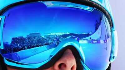 The stadium is mirrored in his goggles in the 1/8 finals of the men’s Snowboard Parallel Slalom at Rosa Khutor Extreme Park at the Sochi 2014 Olympic Games, Krasnaya Polyana, Russia on February 22, 2014. JENS BUETTNER / EPA