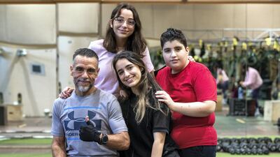Eventually he made the choice to have surgery, and returned to the gym, and he now works out with his children, from left, Hude, 16; Nur, 20; and Abdulvahab, 14 at the Abu Dhabi Country Club. Victor Besa / The National