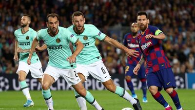 Messi in action with Inter Milan's Stefan de Vrij and Diego Godin. Reuters
