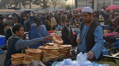 A vendor sells bread at a street market in the Pul-e Khishti area of Kabul. Aid agencies say millions of Afghans are facing severe hunger as winter descends. AFP