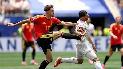 Mehdi Taremi of Iran and Thomas Meunier of Belgium vie for the ball during their World Cup Group G match at the Los Angeles Stadium. AFP