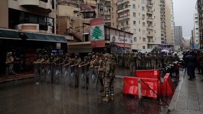 Lebanese security forces stand guard as anti-government protesters go around the homes of deputies and government officials in the northern port city of Tripoli. AFP