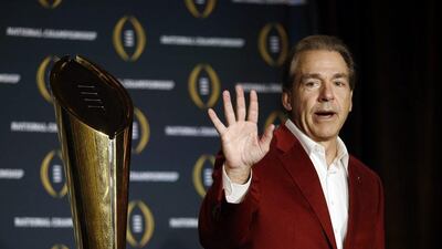 Alabama coach Nick Saban poses with the championship trophy during a news conference for the NCAA college football playoff championship Tuesday, Jan. 12, 2016, in Scottsdale, Ariz. Alabama beat Clemson 45-40 to win the championship. (AP Photo/Morry Gash)