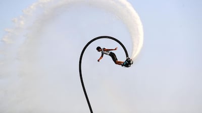 People compete in the flyboard section of the Dubai Watersports Summer Week.