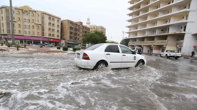A motorist drives a car in a flooded street in the Qatari capital Doha following heavy rainfall on November 25. AFP Photo