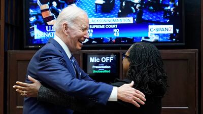 President Joe Biden goes to hug Supreme Court nominee Judge Ketanji Brown Jackson. AP