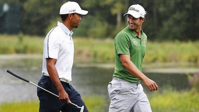Tiger Woods, left, secured five titles this year while Adam Scott won the Masters at Augusta. Jim Rogash / AFP