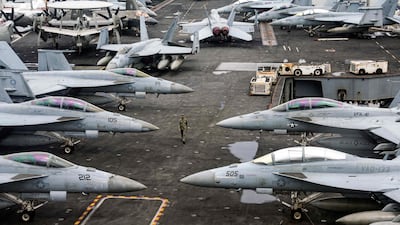 Fighter jets on the flight deck of the USS Abraham Lincoln aircraft carrier during a media tour, off Malaysia in 2024. The ship has now led a US deployment to the Middle East. AFP