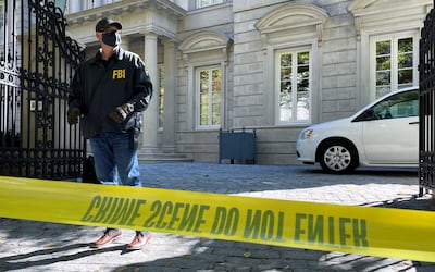 An FBI agent mans his post as the US law enforcement agency conducted a raid at Russian oligarch Oleg Deripaska's home in Washington. Reuters