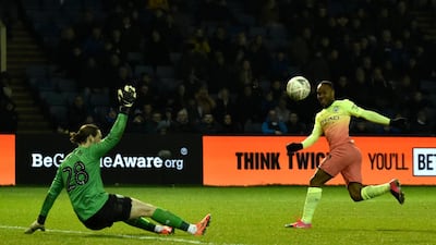 Sheffield Wednesday goalkeeper Joe Wildsmith saves from Manchester City's Raheem Sterling. AP