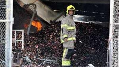 A firefighter surveys the damage in yesterday's market that gutted 24 shops.
