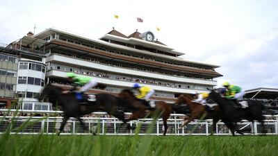 A general view as runners pass the grandstands at Newbury racecourse in England. Alan Crowhurst / Getty Images