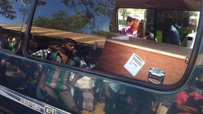 People gather around the ambulance as one of the bodies of the Al Ain crash arrives in a coffin from Abu Dhabi to the Coronation Hight School in Fatickchari, Bangladesh. Silvia Razgova / The National