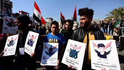 Iraqi university students hold photos of protesters allegedly killed in the continuing unrest during a protest in central Baghdad, Iraq. EPA