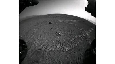 A photograph of Mars released by Nasa last week shows the tracks of its Curiosity Rover as it completes its first test. EPA/NASA JPL CALTECH