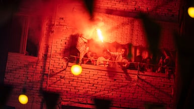 Revellers ignite flares as they gather for a mass iftar in the Matareya district of Cairo, Egypt. EPA