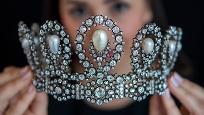 A Sotheby's employee displays a diamond and pearl tiara passed down through generations of the Italian royal family. AP Photo