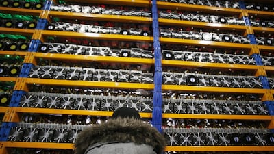 An employee checks the fan on a mining machine at a cryptocurrency farming facility in Quebec, Canada. Investors in digital currencies should be prepared for a wild ride. Christinne Muschi/Bloomberg