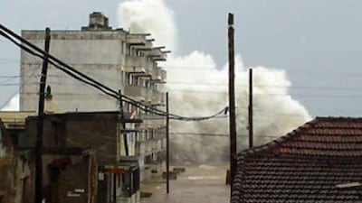 A wave with a height over the one of a five-story building hits the waterfront in Baracoa, eastern Cuba on the impending arrival of Hurricane Ike, on September 7.