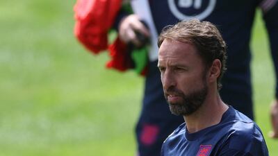 Manager Gareth Southgate holds an England cap during training. Reuters