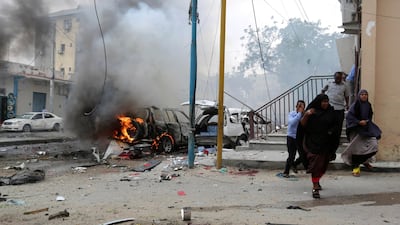 Civilians run from the scene of an explosion in Maka al Mukaram road in Mogadishu, Somalia, July 30, 2017 - the day on which the US military said it killed Ali Mohamed Hussein, a senior Al Shabab commander in a drone air strike. Feisal Omar / Reuters