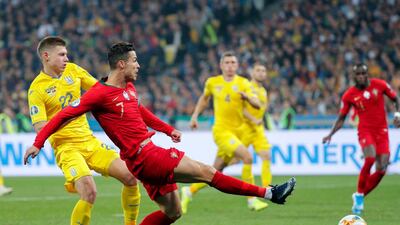 epa07921198 Cristiano Ronaldo (C) of Portugal and Mykola Matviyenko (L) of Ukraine in action during the UEFA Euro 2020 qualifying, group B, soccer match between Ukraine and Portugal in Kiev, Ukraine, 14 October 2019. EPA/SERGEY DOLZHENKO