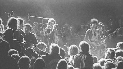 Mick Jagger and Keith Richards of the Rolling Stones warily eye the Hell's Angels at the Altamont Speedway in California, where they had been hired as security in 1969. Getty
