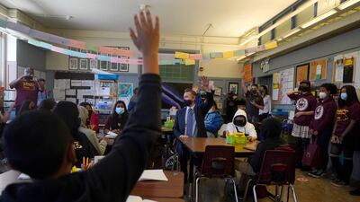 Gavin Newsom, middle, speaks to students in a seventh grade science class at James Denman Middle School in San Francisco. AP Photo