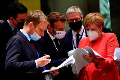 German Chancellor Angela Merkel, right, will effectively hand over the leadership role of Europe to French President Emmanuel Macron, centre, when she retires this year. AP Photo