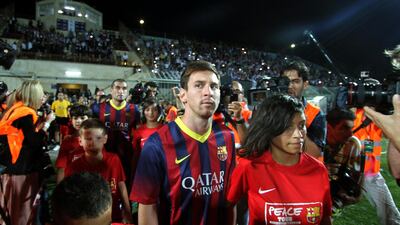 Lionel Messi and his Barcelona teammates held a coaching clinic at a stadium in the West Bank city of Hebron in 2013. Nasser Shiyoukhi / AP Photo
