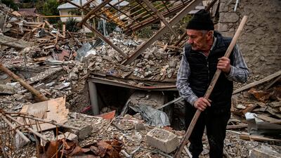 Retired police officer Guennadi Avanessian, 73, searches for belongings in the remains of his house, which he said was destroyed by Azeri shelling, in the city of Stepanakert. AFP