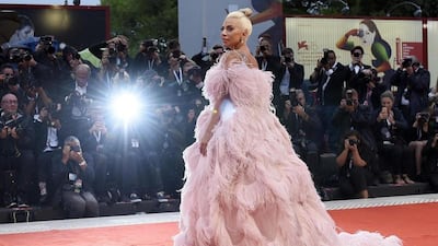 LADY GAGA, AUGUST 2018: Another Gaga look that deserves attention, this study in feathers is by Valentino. It is remarkably elegant for something so frou-frou. It's probably our favourite Gaga fashion moment of all time. EPA
