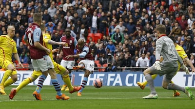 Aston Villa’s Fabian Delph shoots and scores the 2-1 winner on Sunday in his side's FA Cup semi-final victory over Liverpool. Kirsty Wigglesworth / AP