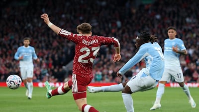 Jeremy Doku curls home a superb second goal for Manchester City. Getty Images
